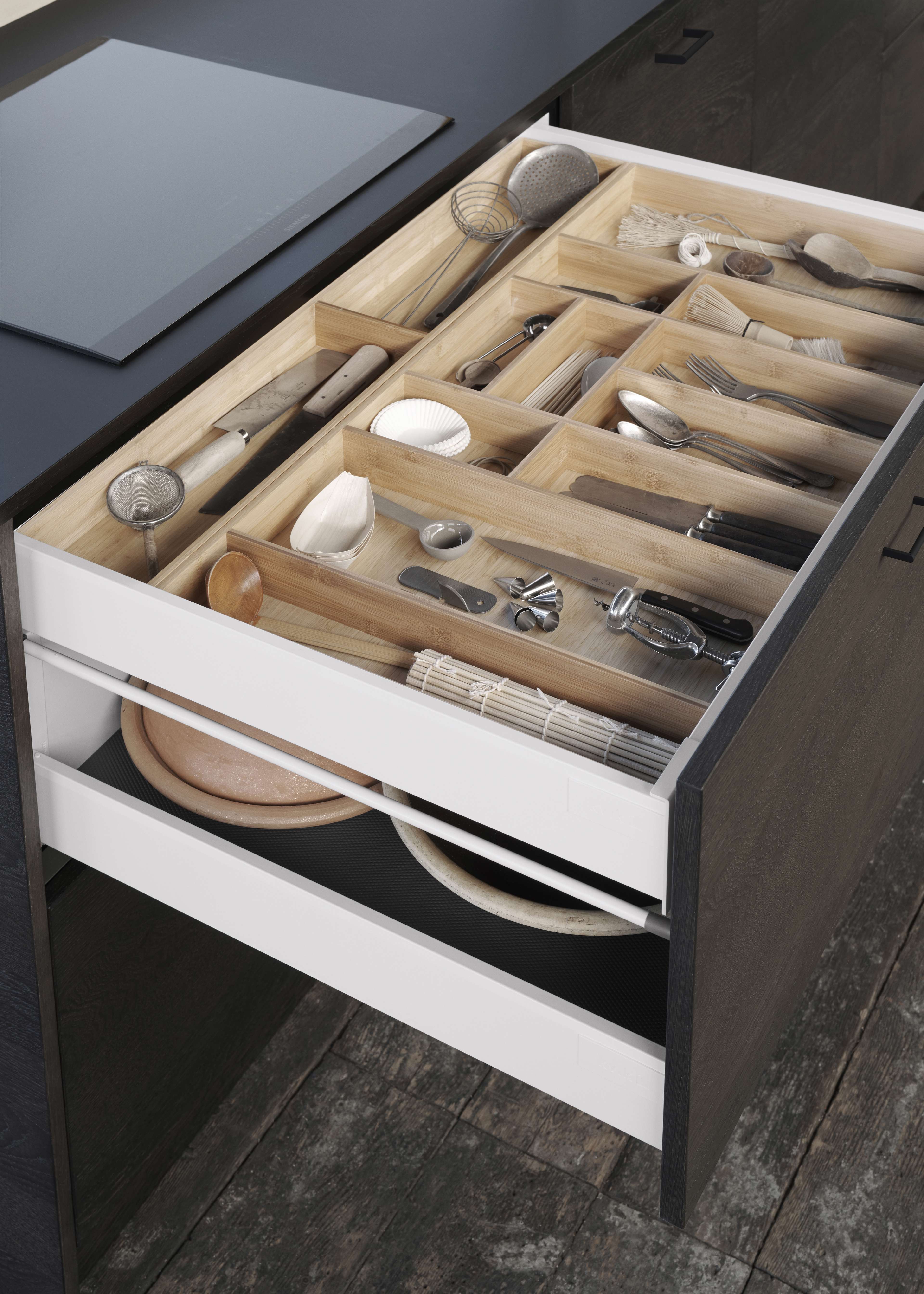 VEDA dark oak kitchen drawer with sleek design, featuring organized cutlery compartments, enhancing modern kitchen functionality and style.