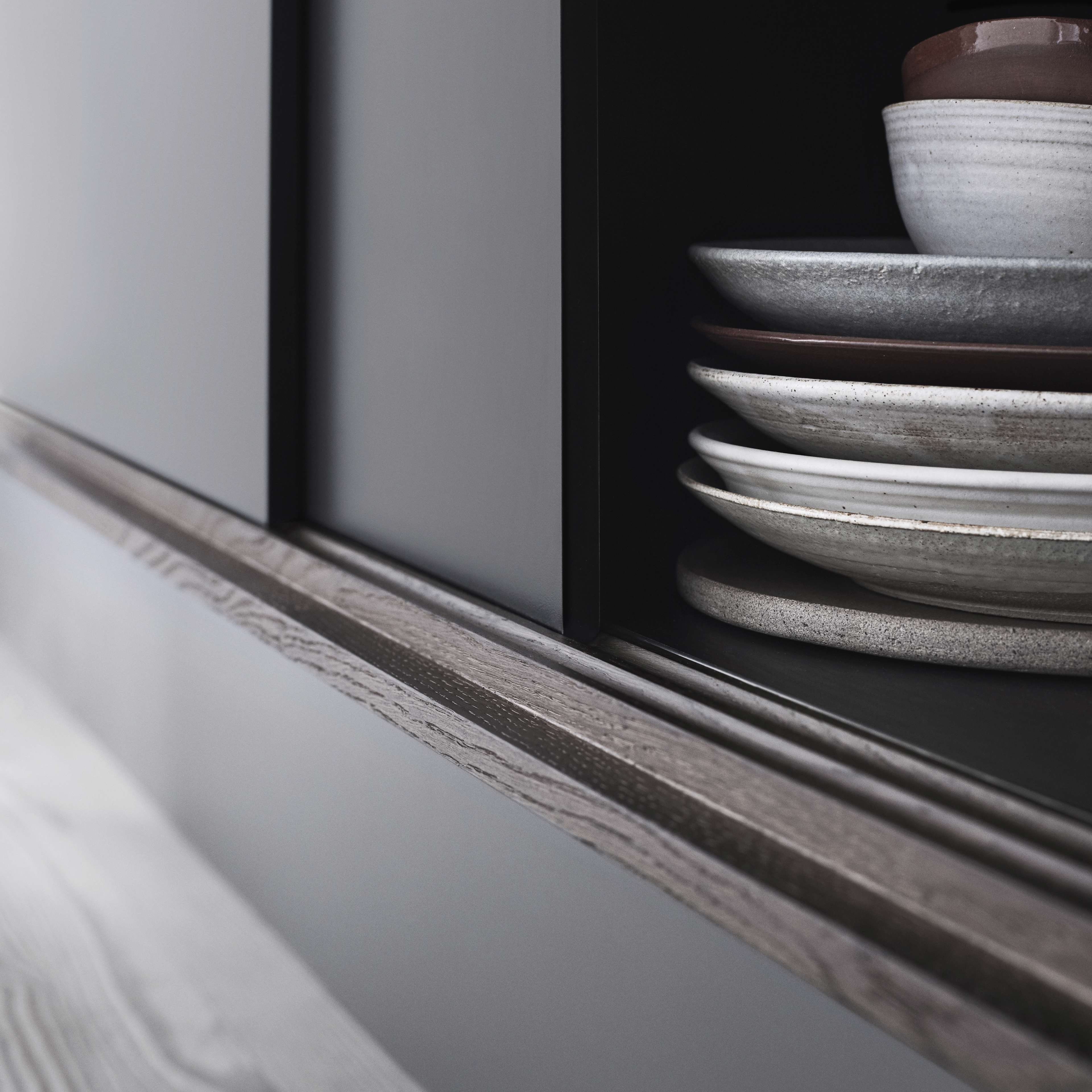 PRATO dark grey kitchen features sleek matte cabinets, blending modern elegance with functional storage, ideal for a contemporary home setting.