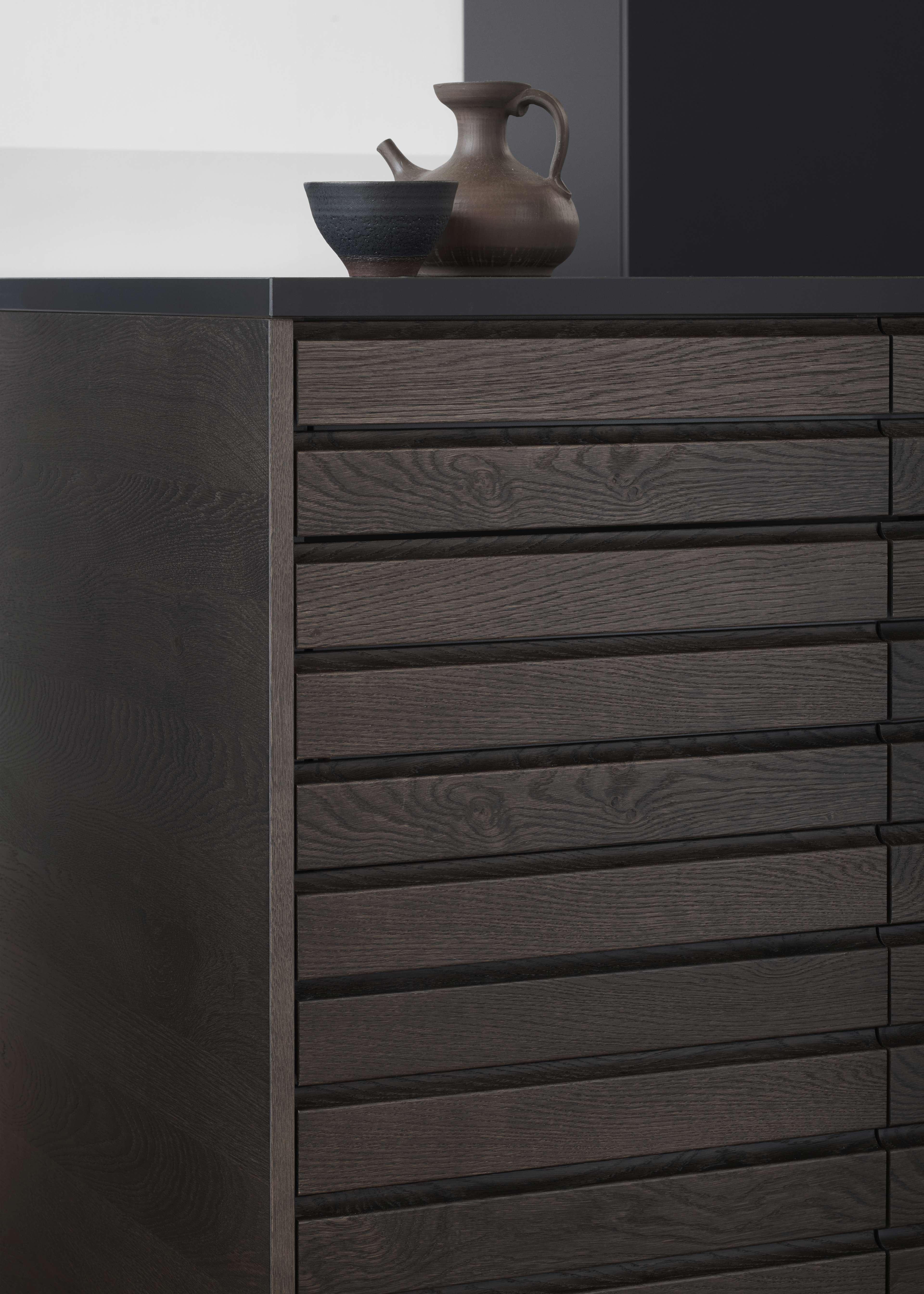 CIMA dark oak kitchen cabinet with horizontal slatted panels, offering a contemporary and refined aesthetic with rich wood grain texture.