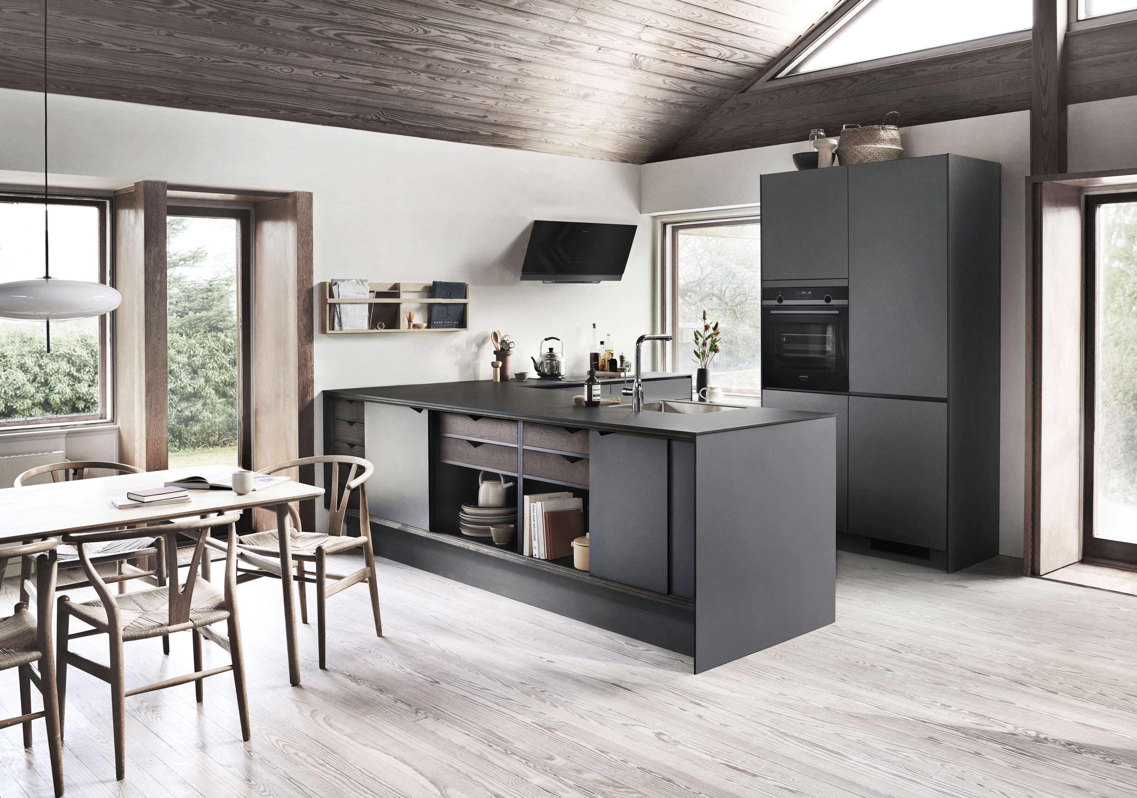 PRATO dark grey kitchen featuring sleek cabinets and modern appliances, creating a minimalist and contemporary cooking space with wood accents.