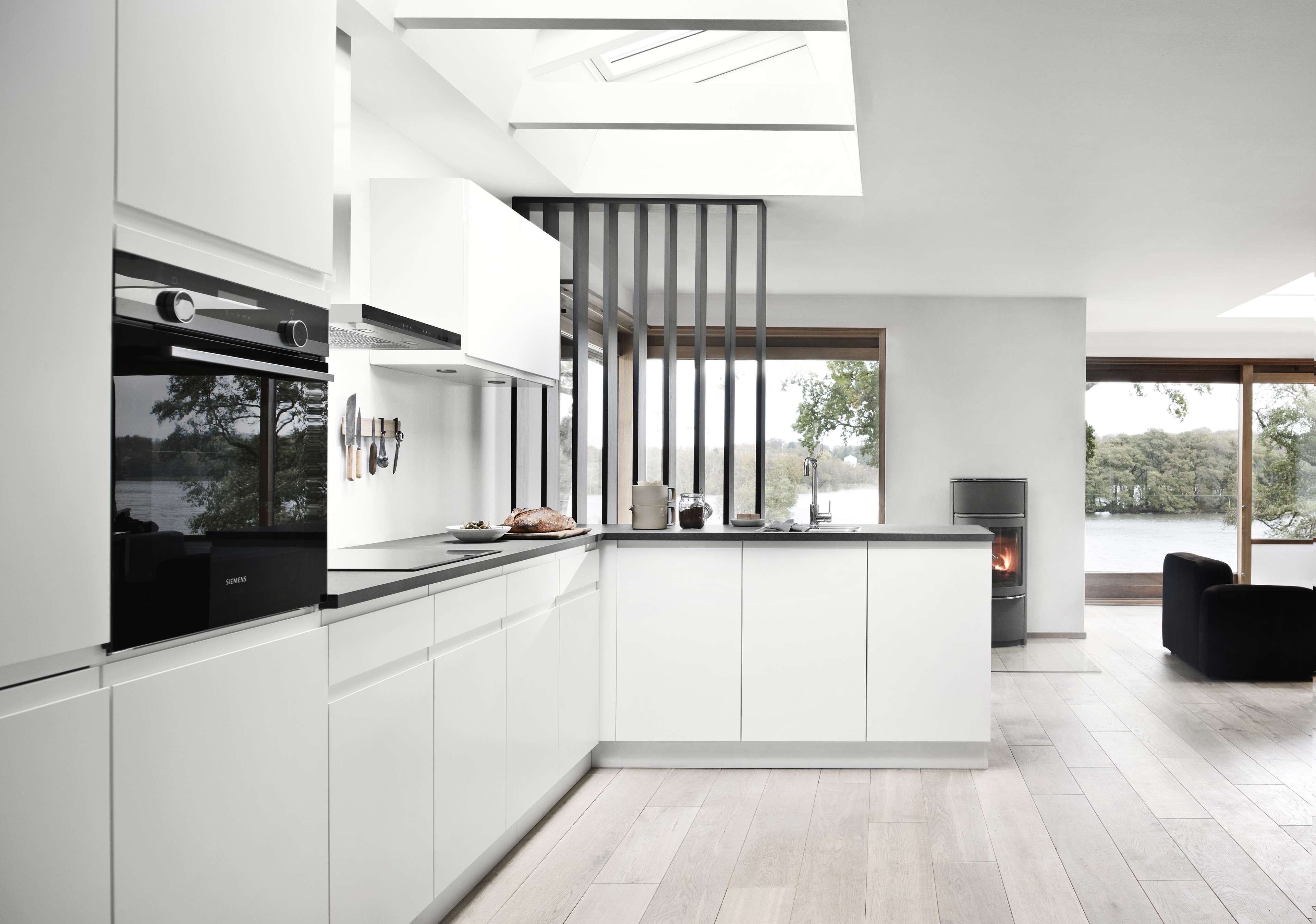 NOLIAM white minimalist kitchen with sleek cabinets and modern design, featuring integrated appliances, emphasizing a clean and bright ambiance.