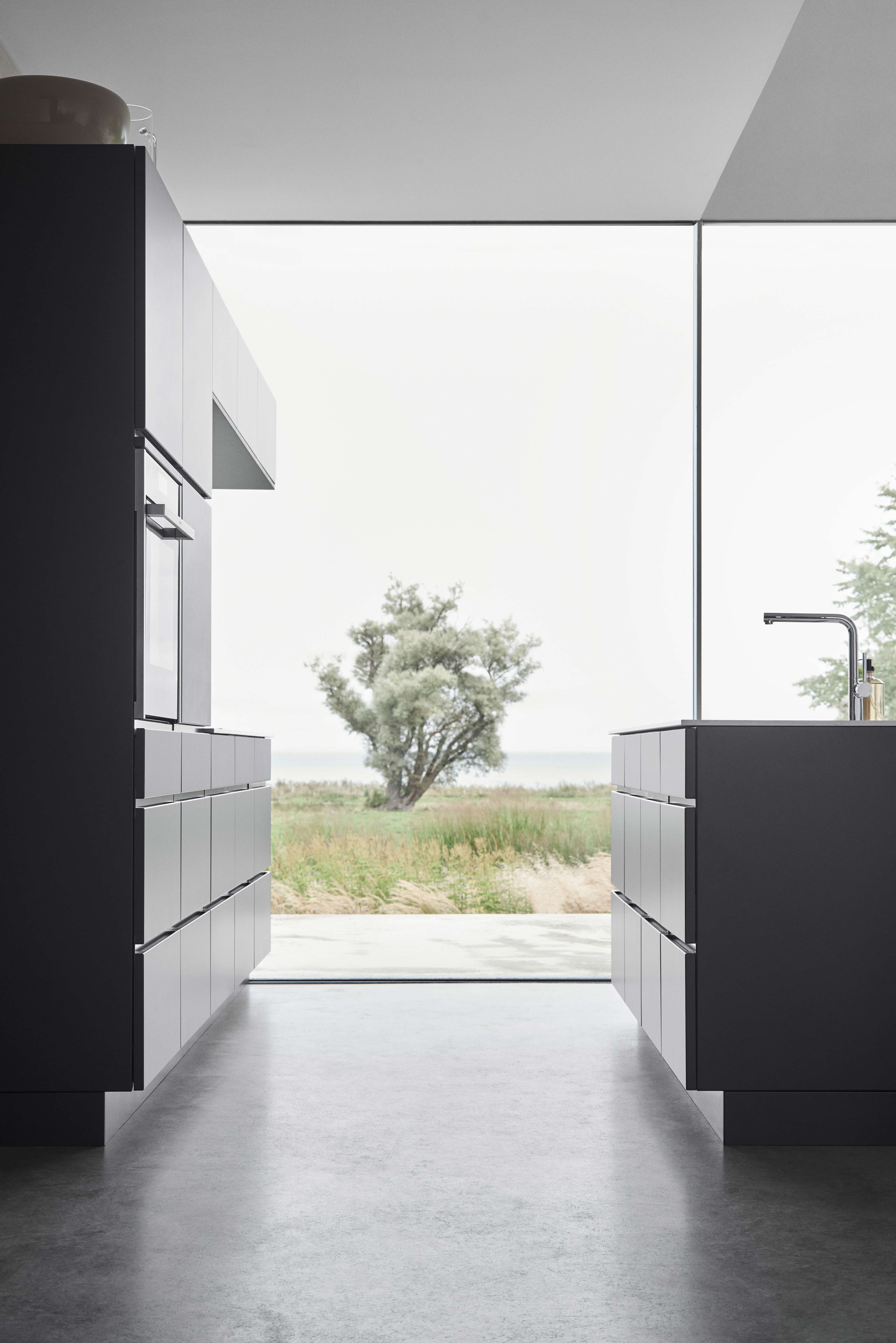 MANO dark grey kitchen cabinets with sleek, minimalist design, enhancing modern aesthetics and creating a sophisticated, functional cooking area.
