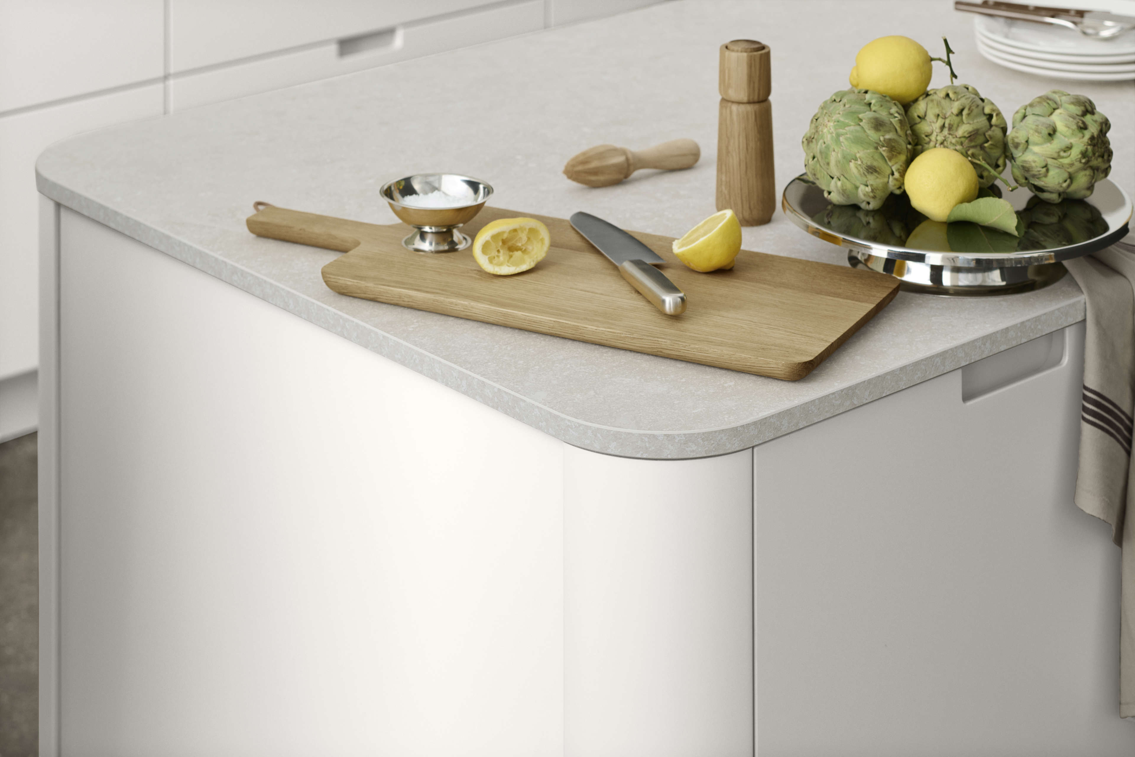 EVENTO white kitchen island with smooth matte finish, featuring seamless cabinetry design, offering a modern and minimalistic aesthetic appeal.