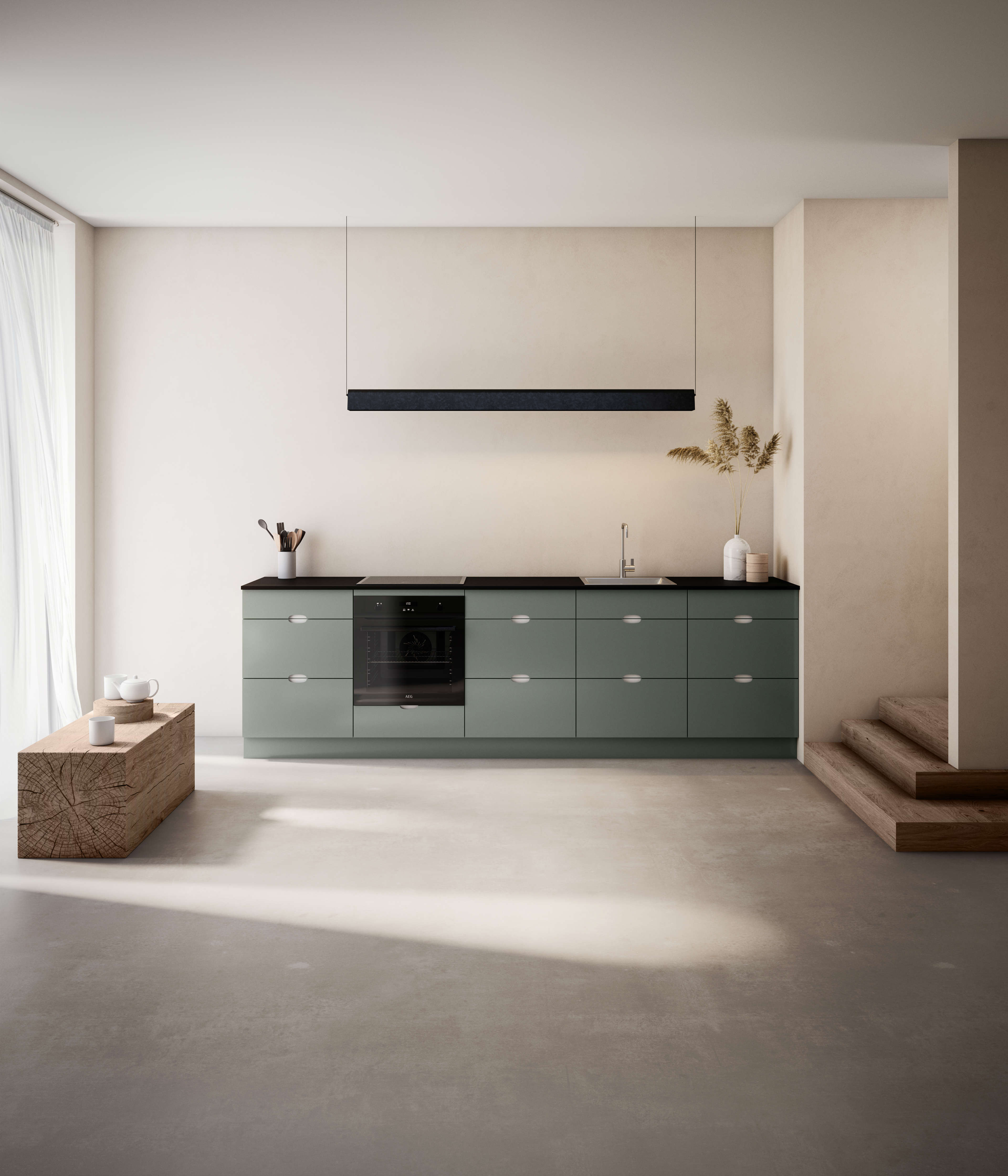 Green kitchen with white handles and an integrated oven