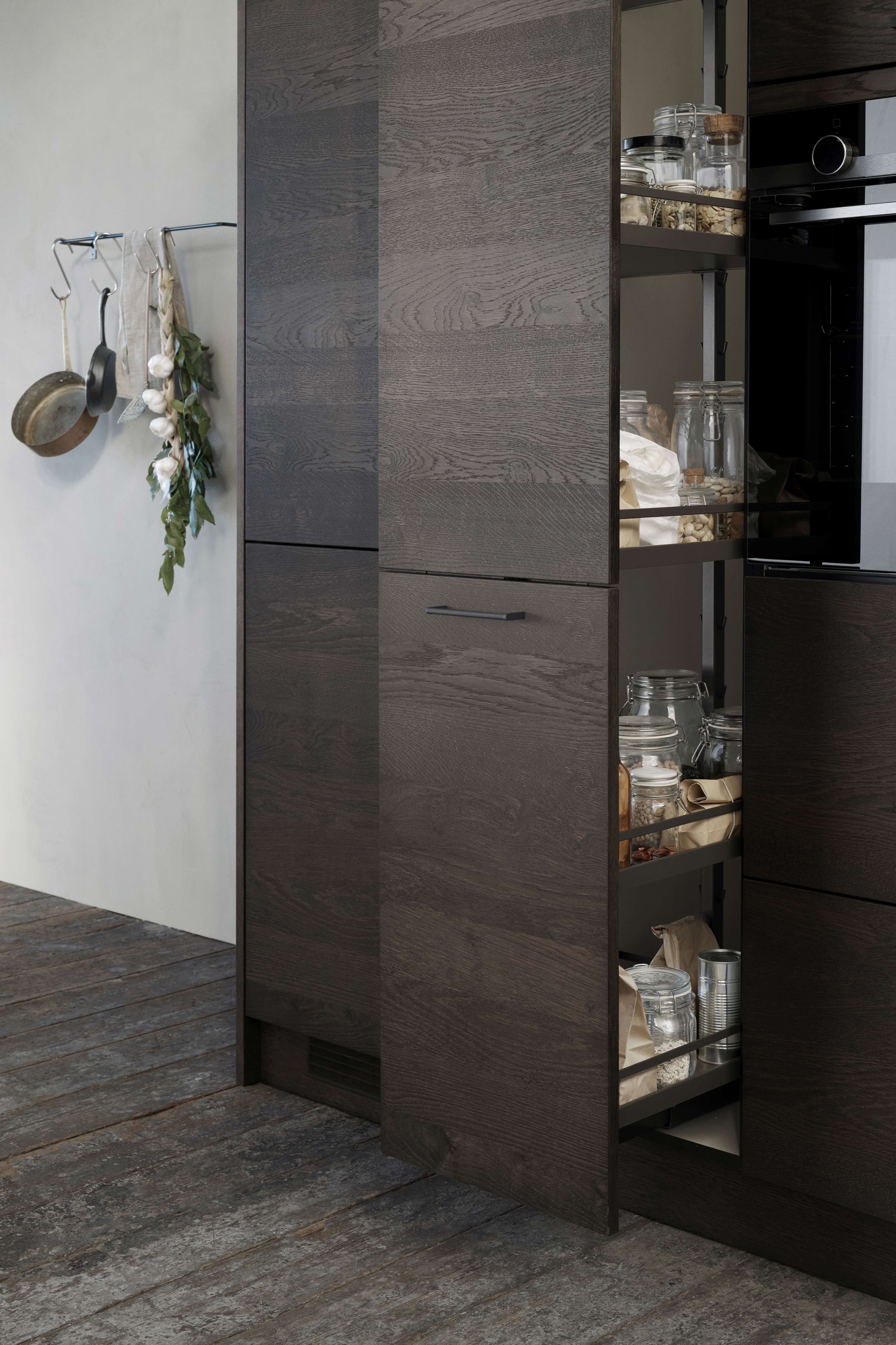 VEDA dark oak kitchen offers a sleek, modern design with rich wood grain texture and concealed storage, enhancing any contemporary space efficiently.