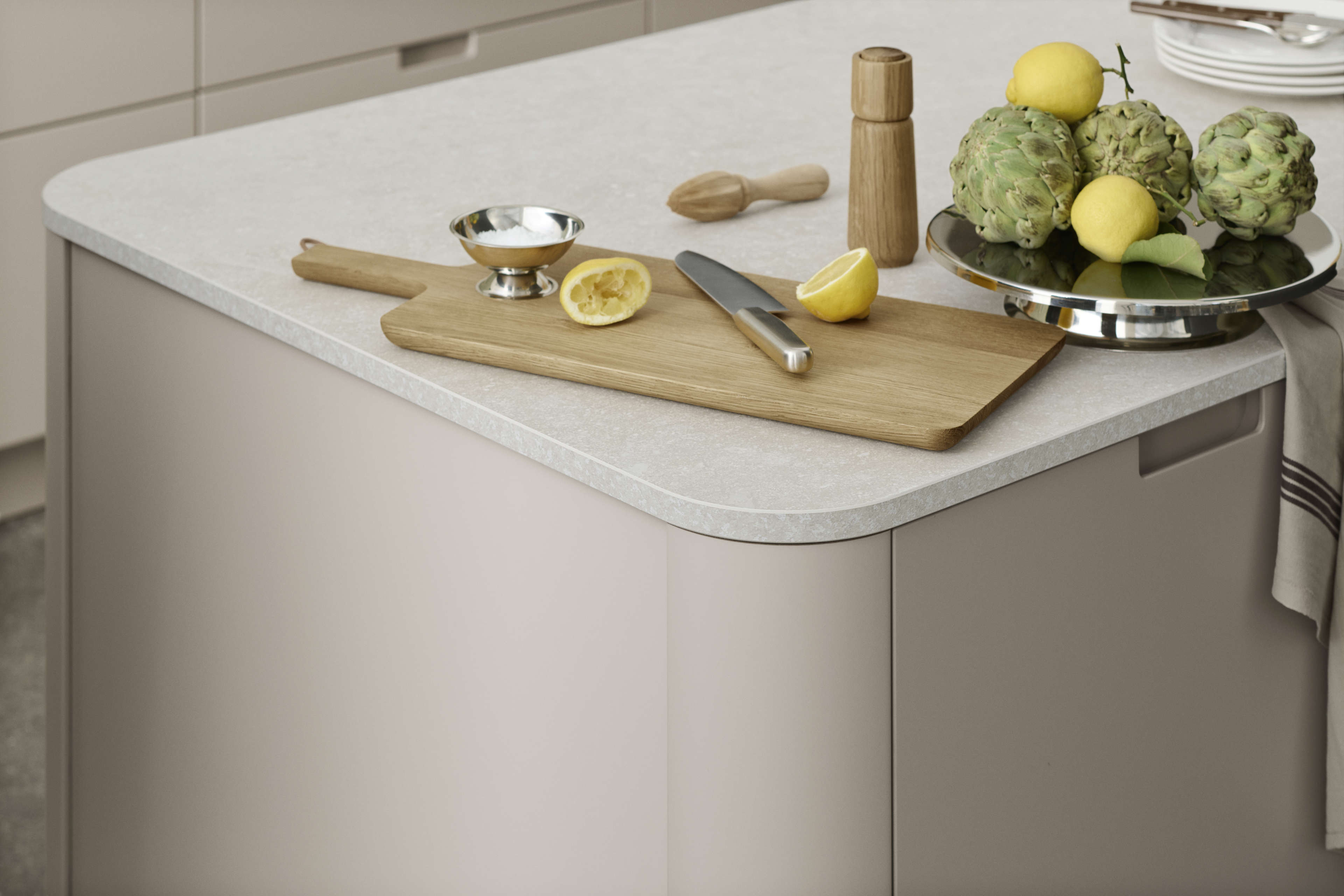 EVENTO arizona beige kitchen island with smooth, rounded countertop edges, showcasing a modern and minimalist design for a stylish cooking space.