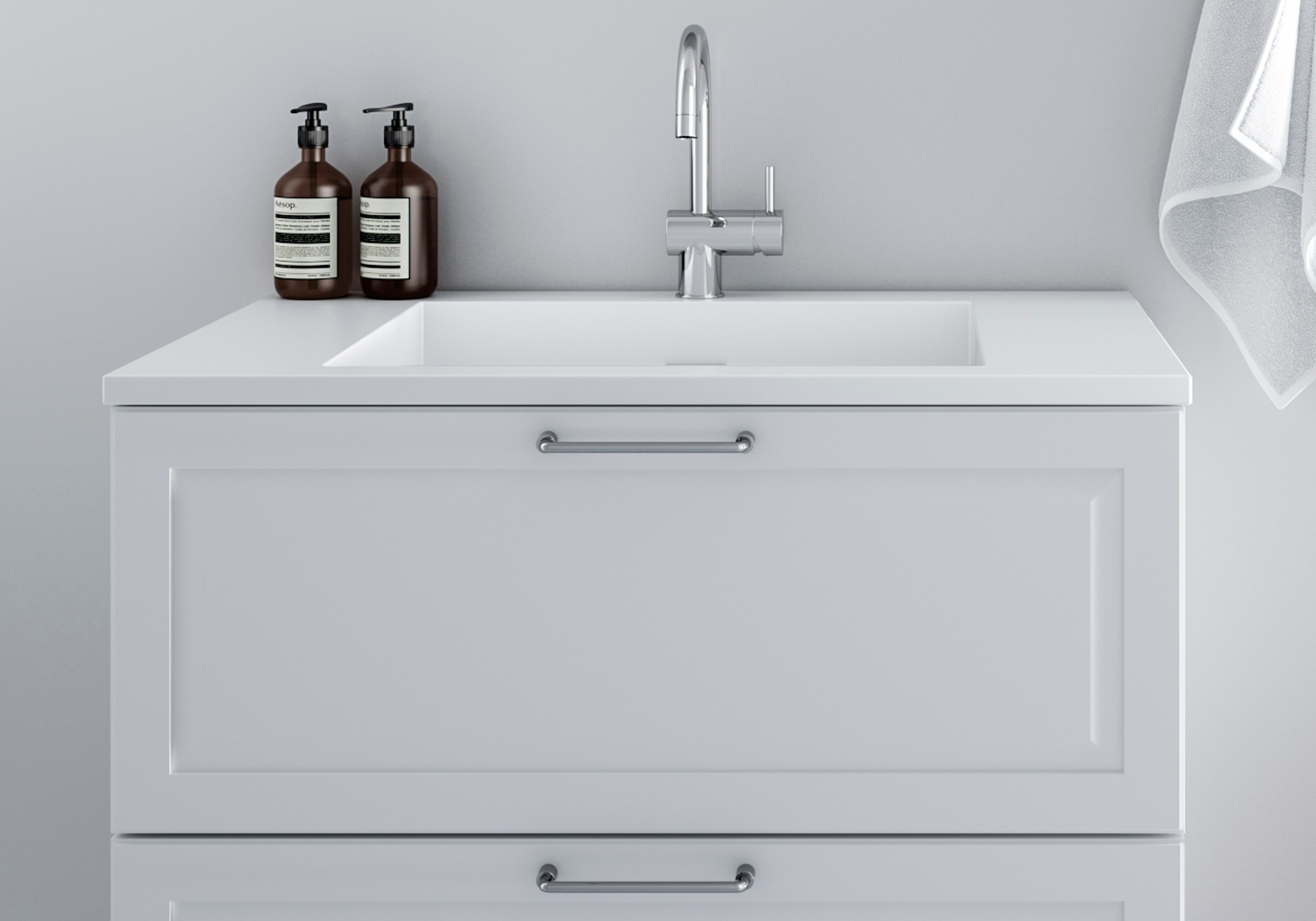 PAVIA hvid badeværelsesvask med et slankt design med moderne håndtag og integreret vask, perfekt til et rent og sofistikeret look.