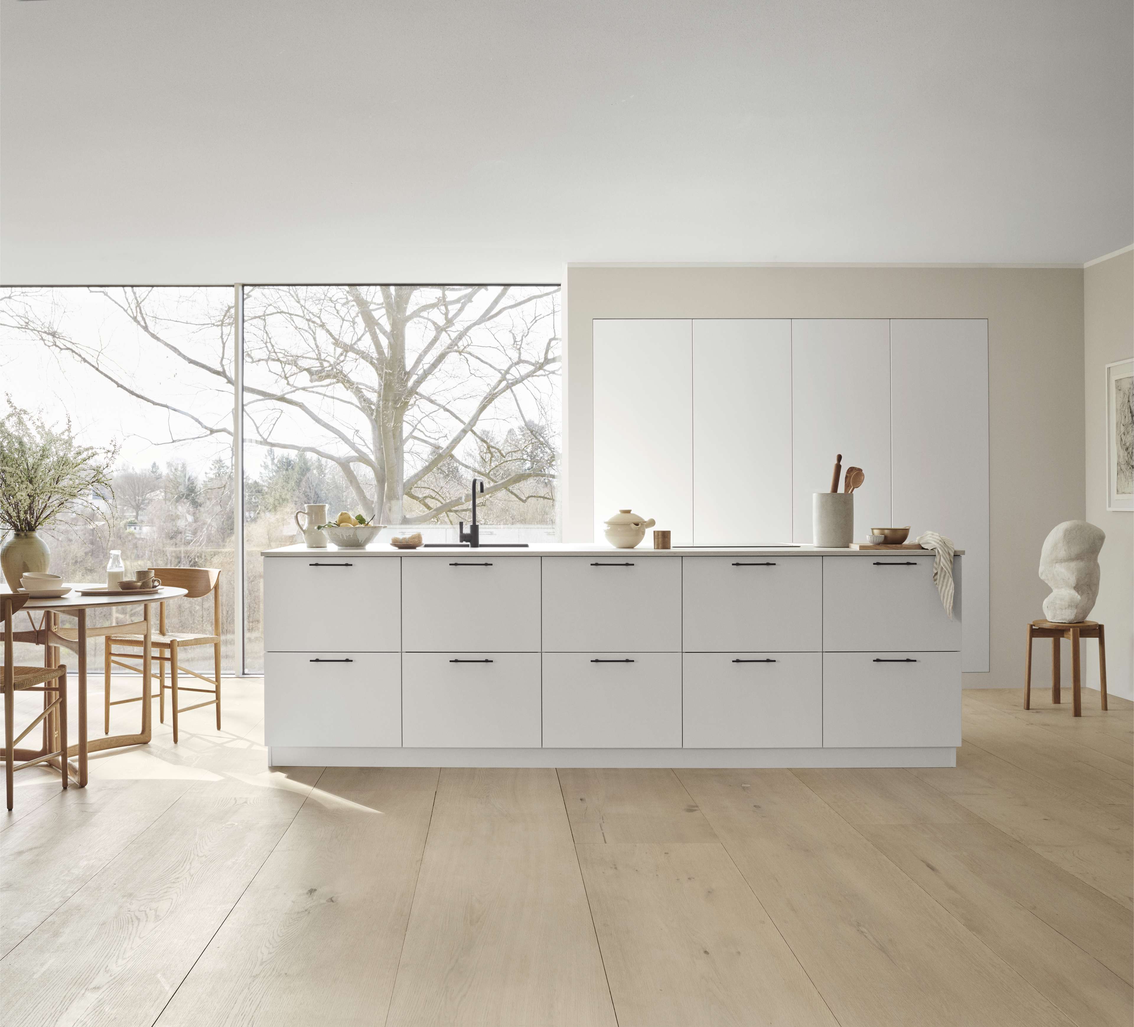 White kitchen with a kitchen island and tall cabinets