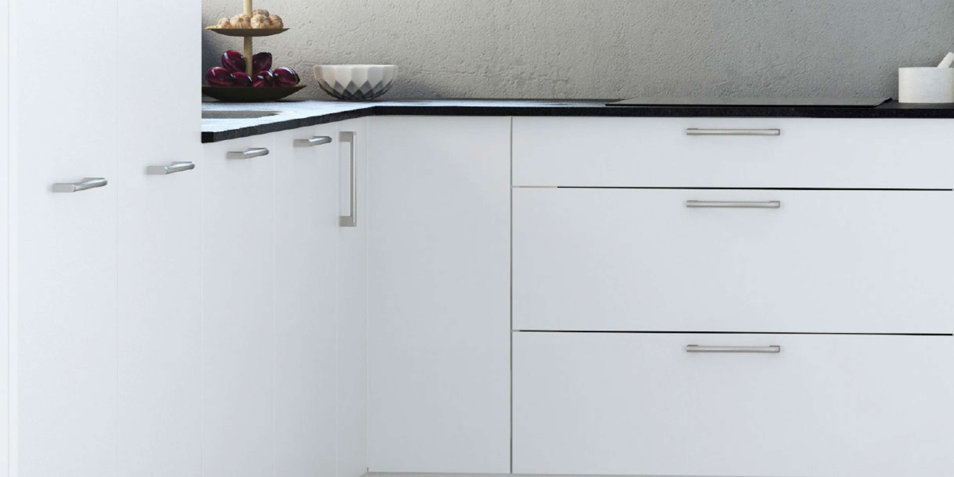 MILK white kitchen cabinetry with sleek handles and a modern minimalist design, enhancing space with a classic yet contemporary aesthetic.