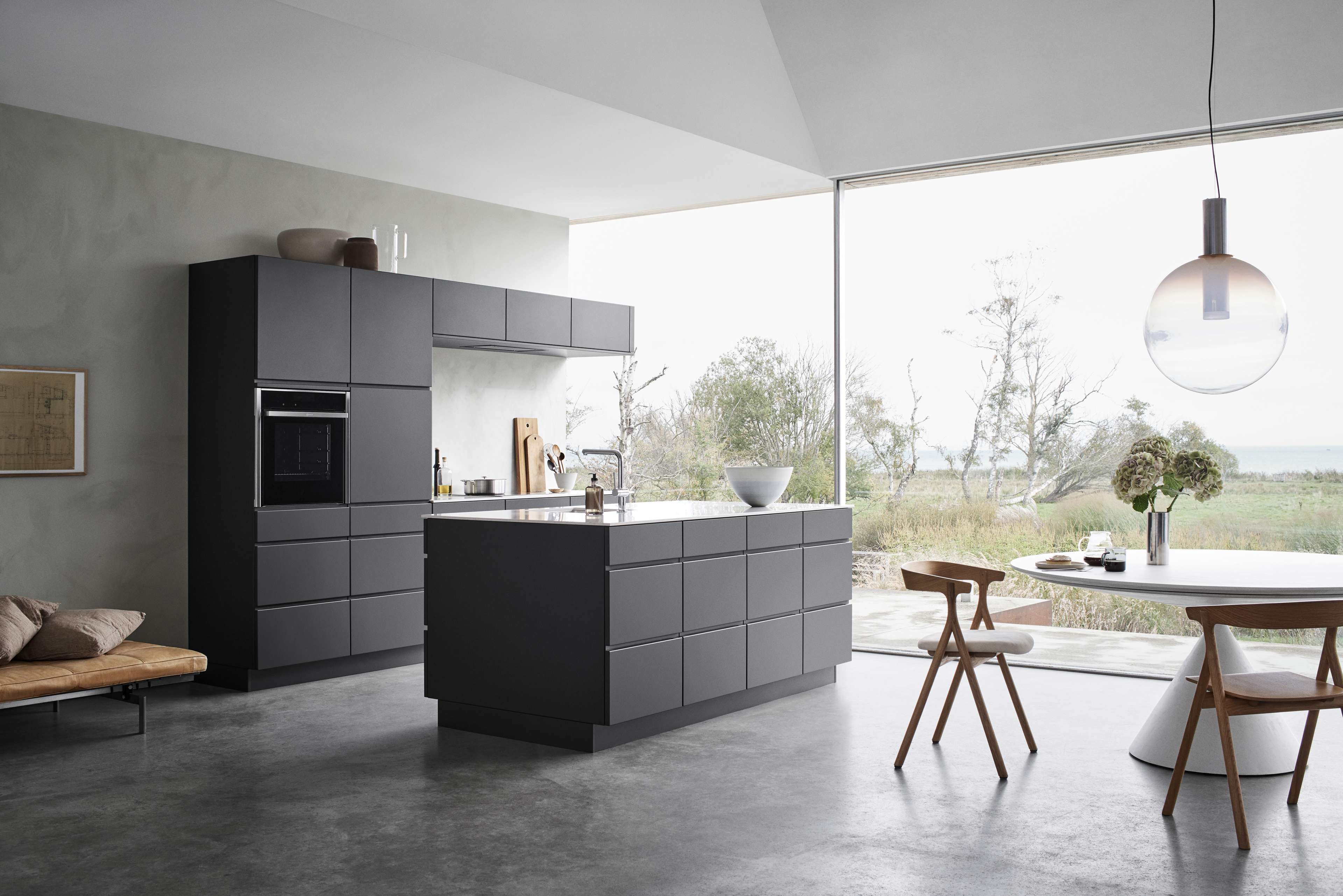 MANO dark grey kitchen cabinets with sleek, handleless design exuding modern minimalism, enhancing the contemporary style of any kitchen space.