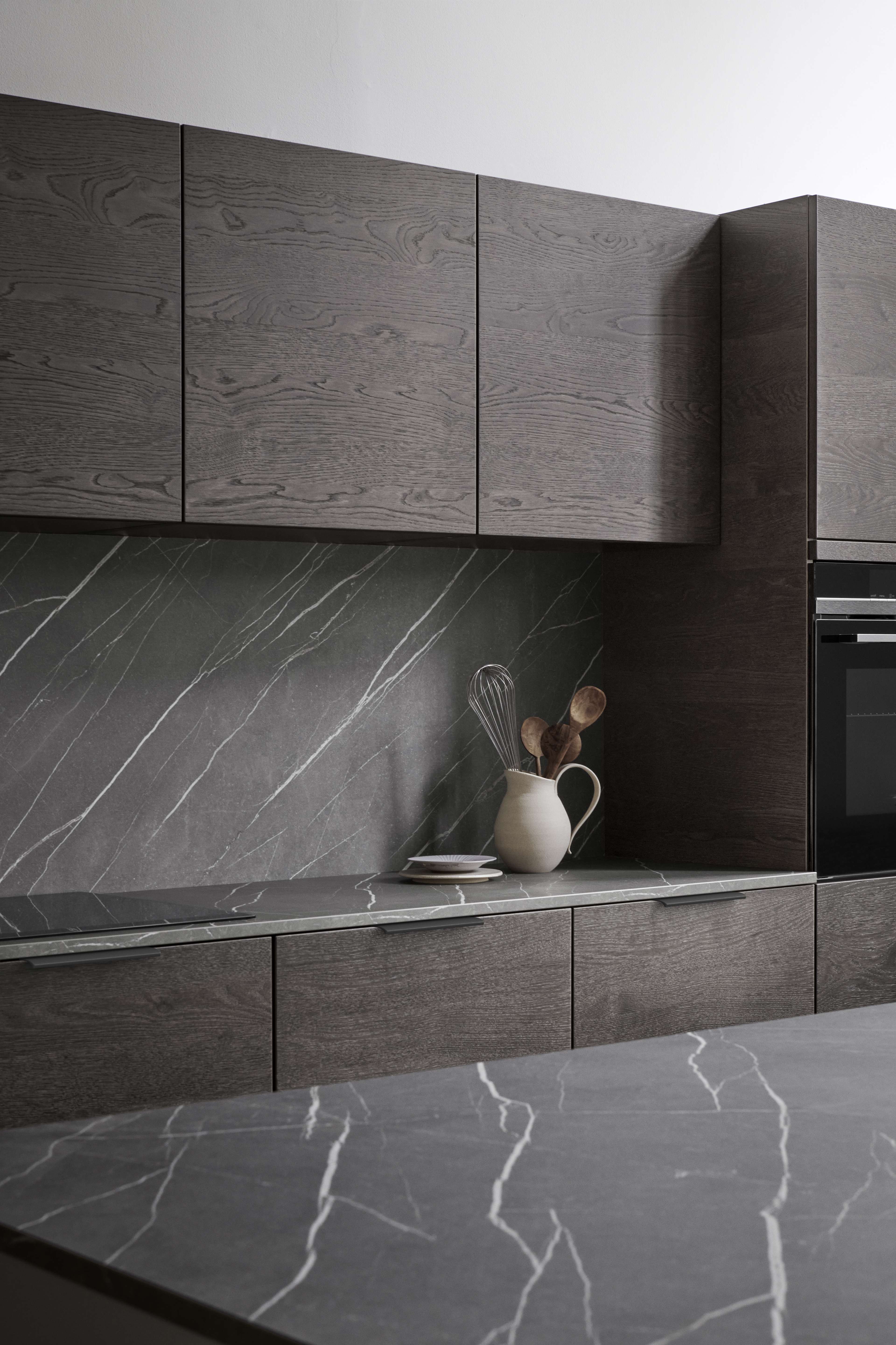 VEDA Touch pure grey dark oak kitchen features elegant wood grain cabinets, complemented by sleek marble-like countertops for a modern aesthetic.