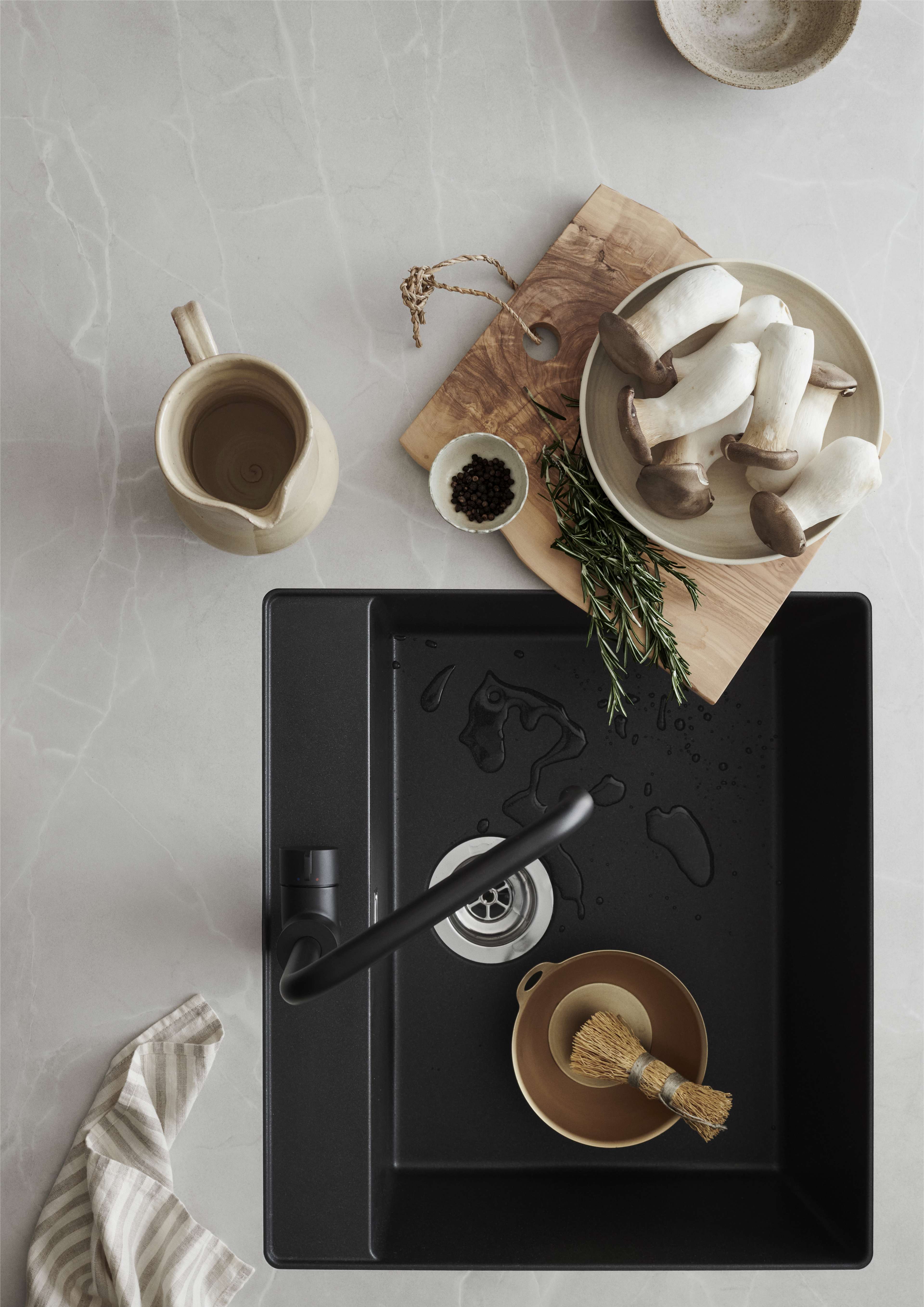 VEDA white kitchen showcasing a sleek, modern design with a matte black sink, providing a minimalist and elegant space for daily needs.