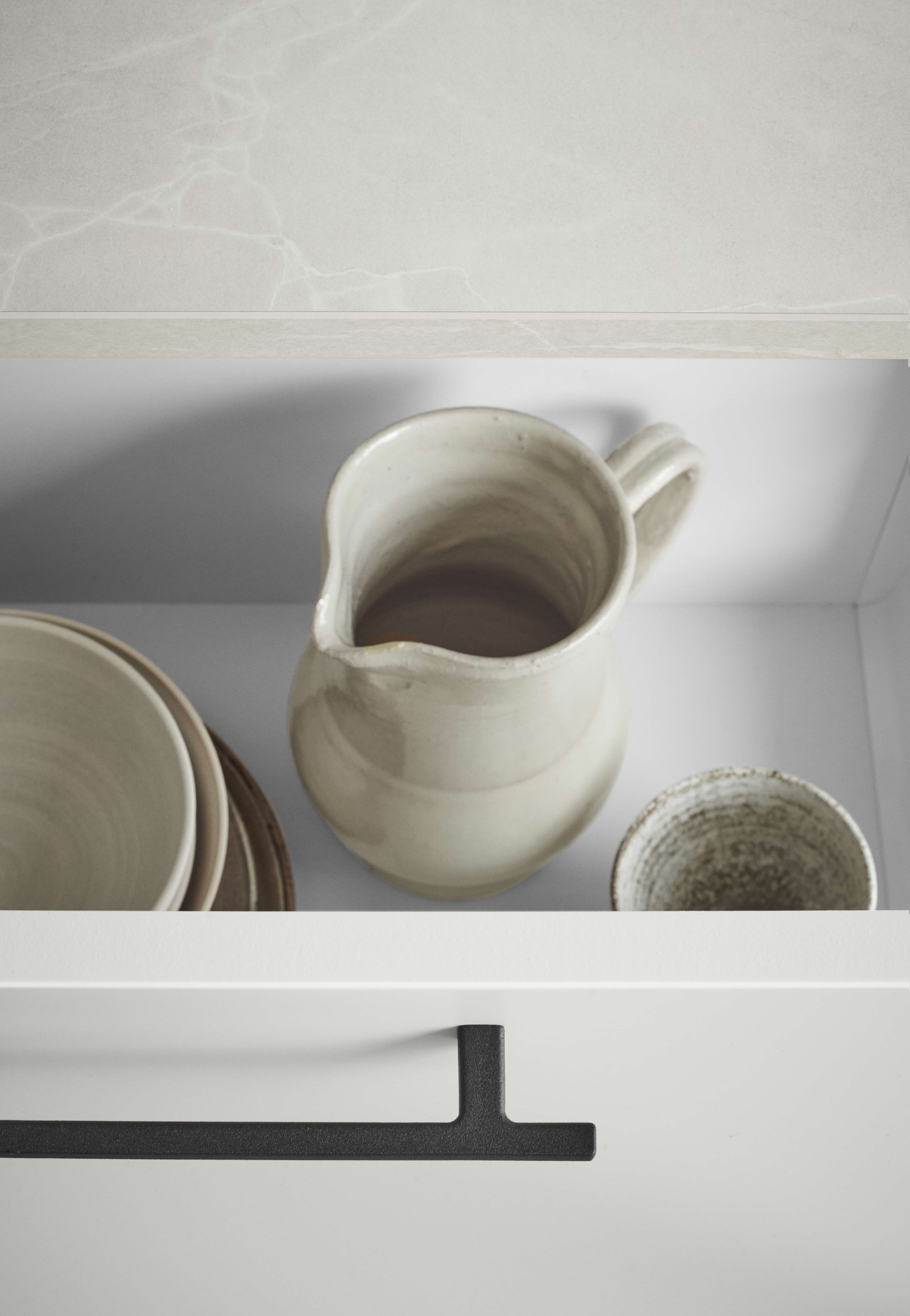 White kitchen drawer with black handles