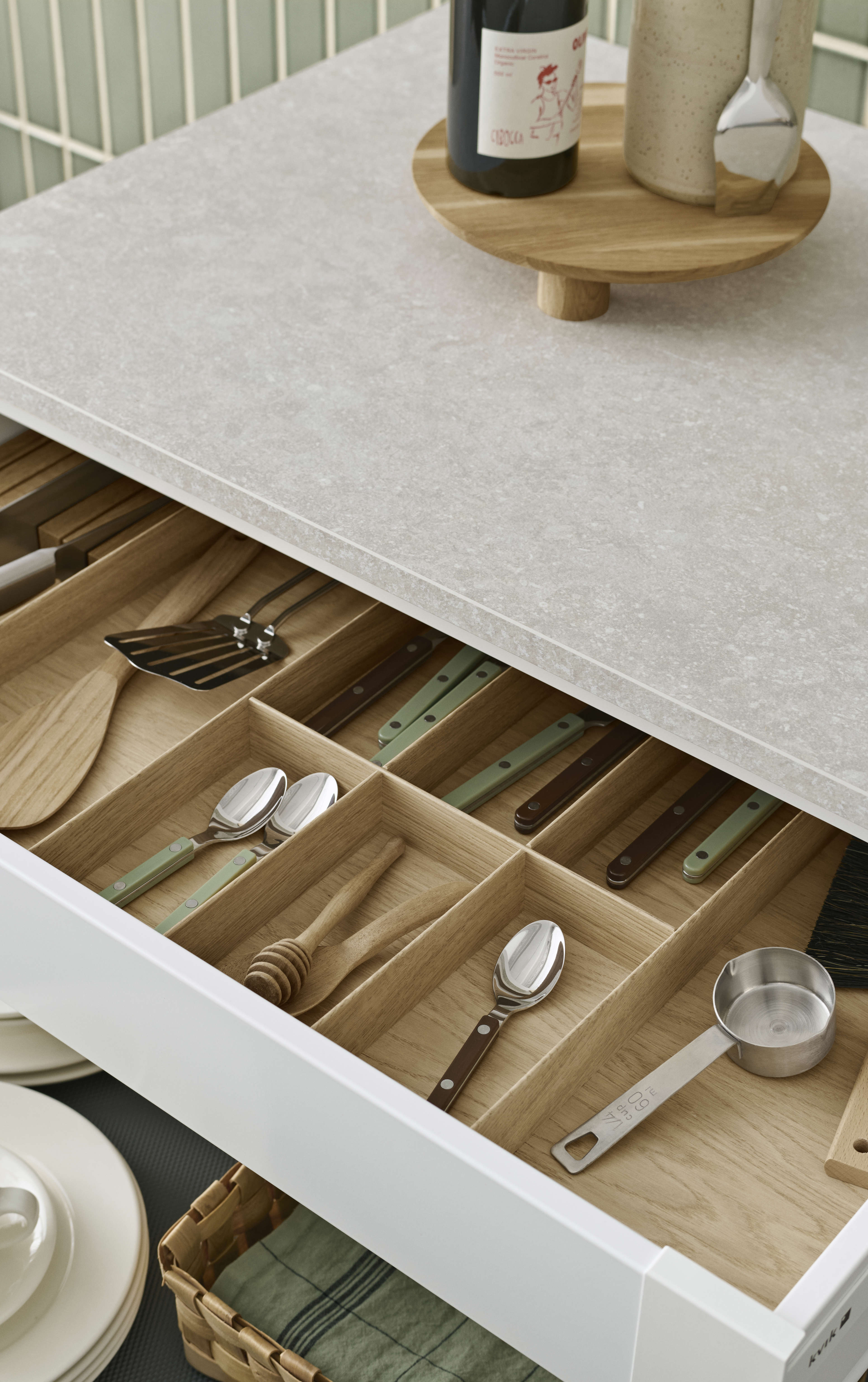 EVENTO arizona beige kitchen countertop with organized wooden utensil drawer, providing a minimalist and functional Nordic style storage solution.