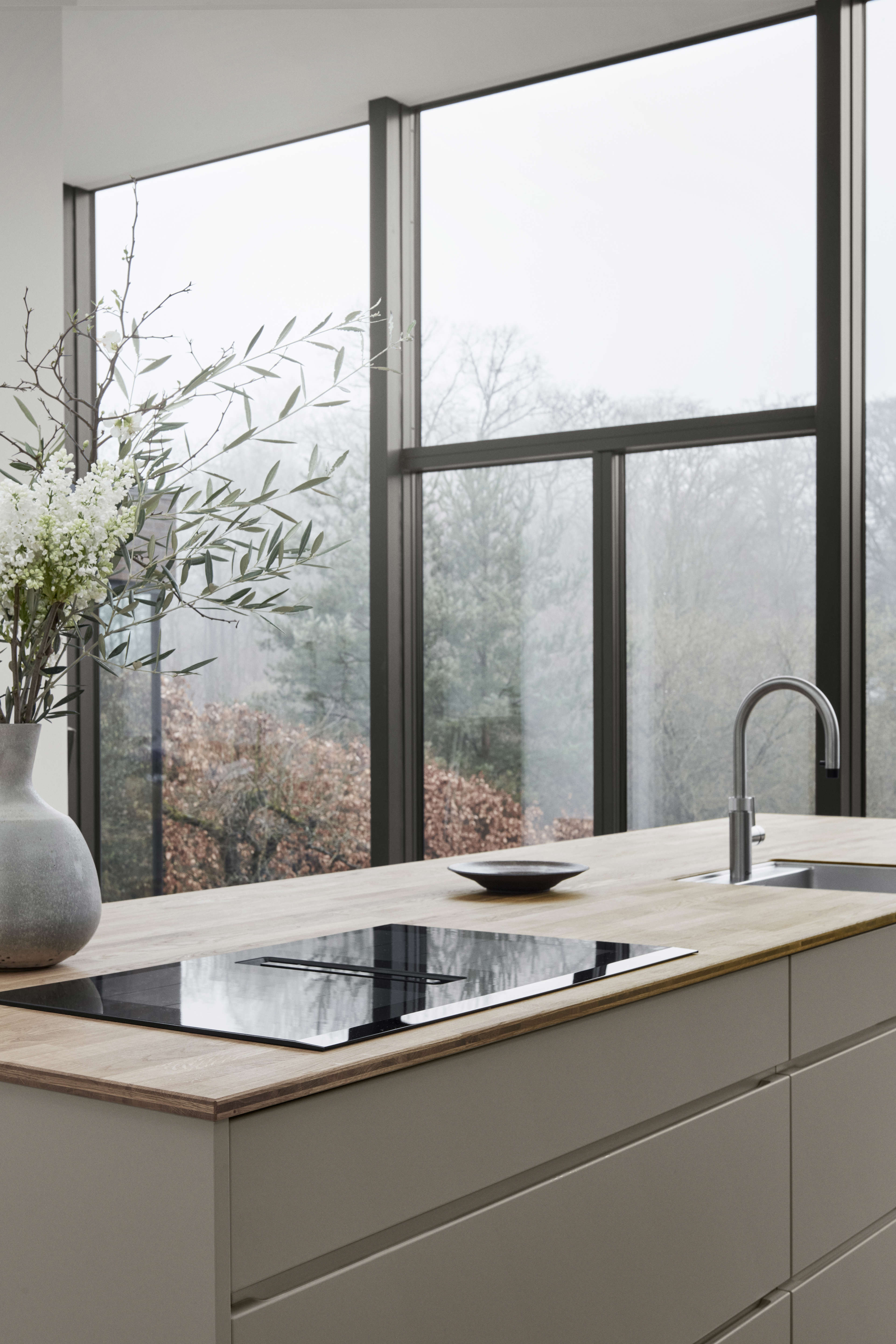 MANO arizona beige kitchen island with sleek induction cooktop and minimalist sink design, creating a modern and elegant culinary space.