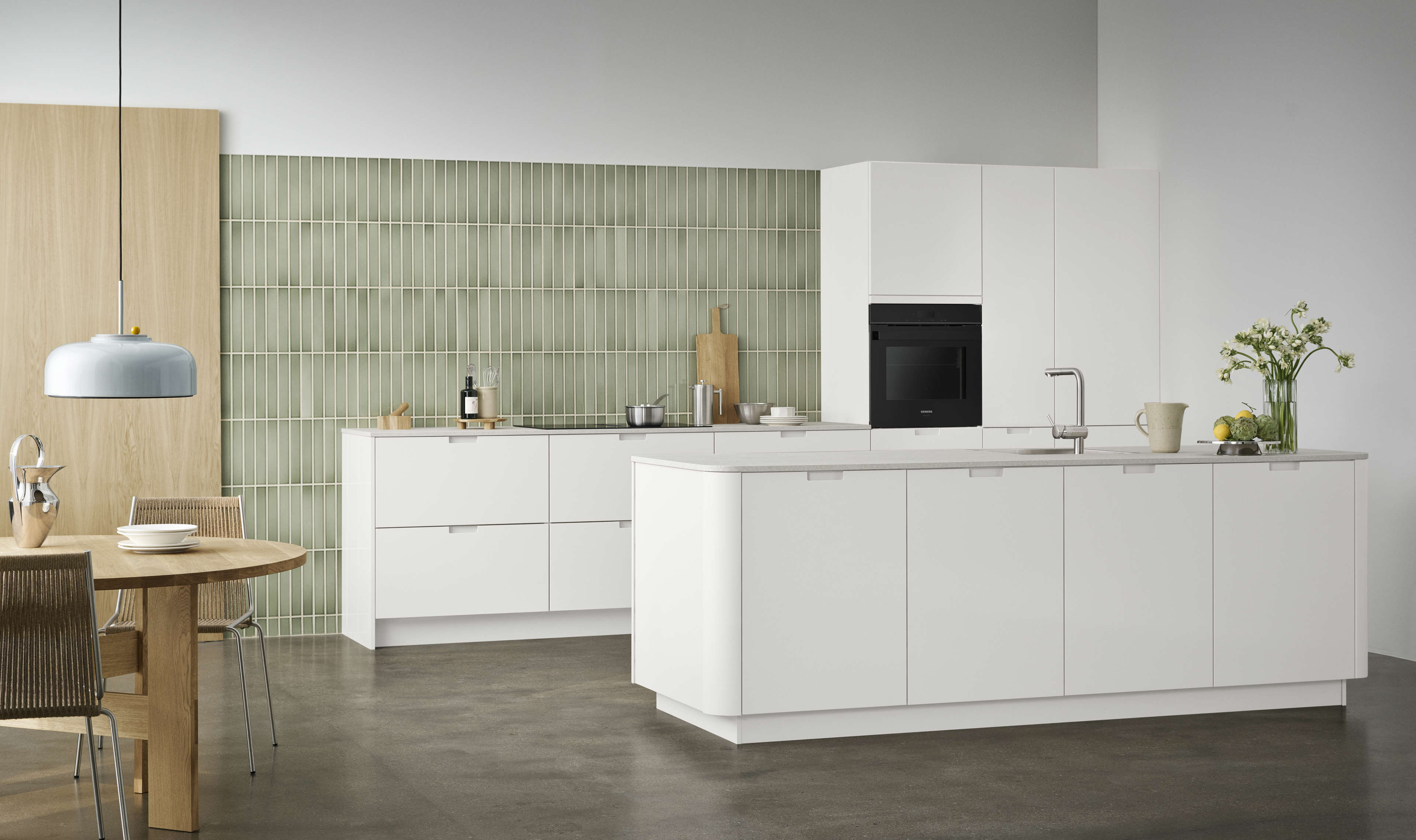 EVENTO white kitchen with sleek cabinets and integrated oven, featuring a minimalist design and modern style with smooth surfaces and clean lines.